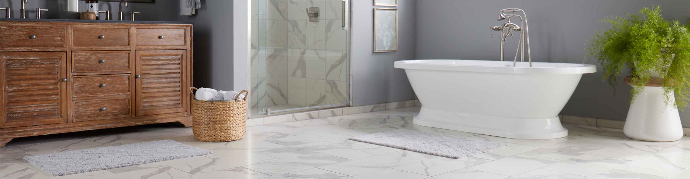 bathroom with tile flooring, white tub, and backsplash in bathroom
